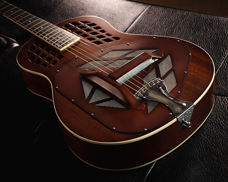 Acoustic guitar with a metal deals resonator built into the body