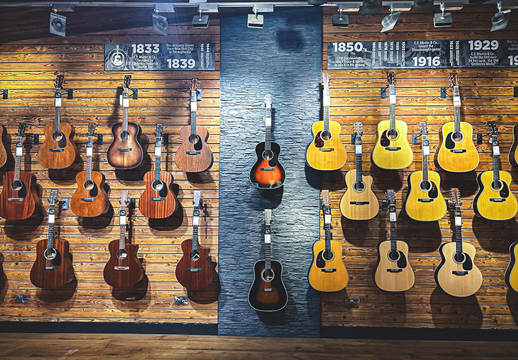 a photo of music store wall full of Martin acoustic guitars
